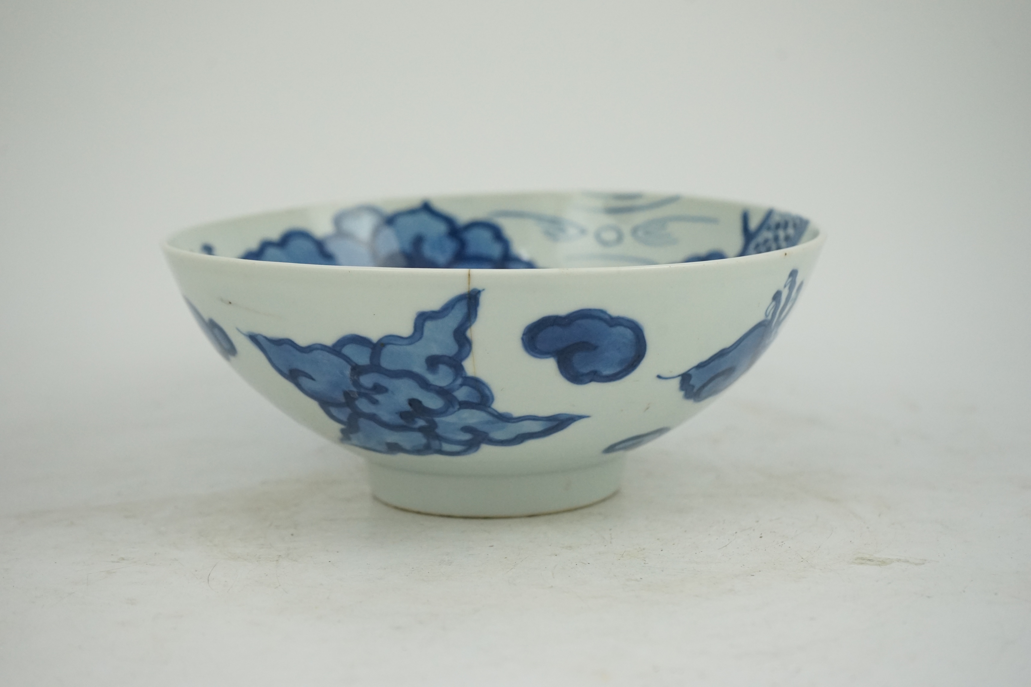 A Chinese blue and white ‘cloud and dragon’ bowl, Yongzheng mark and period (1723-35)